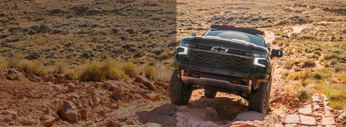 Off-road 2019+ Silverado navigating rocky terrain with upgraded suspension from PEAK SUSPENSION, featuring DEAVER M27 Leaf Pack for a 1.5" lift.
