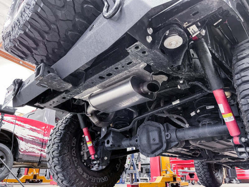 Installed Banks Power 18-22 Jeep Wrangler 3.6L 4 Door Monster Sport Exhaust System from underneath the vehicle, showing its sleek design and improved ground clearance for off-road adventures.