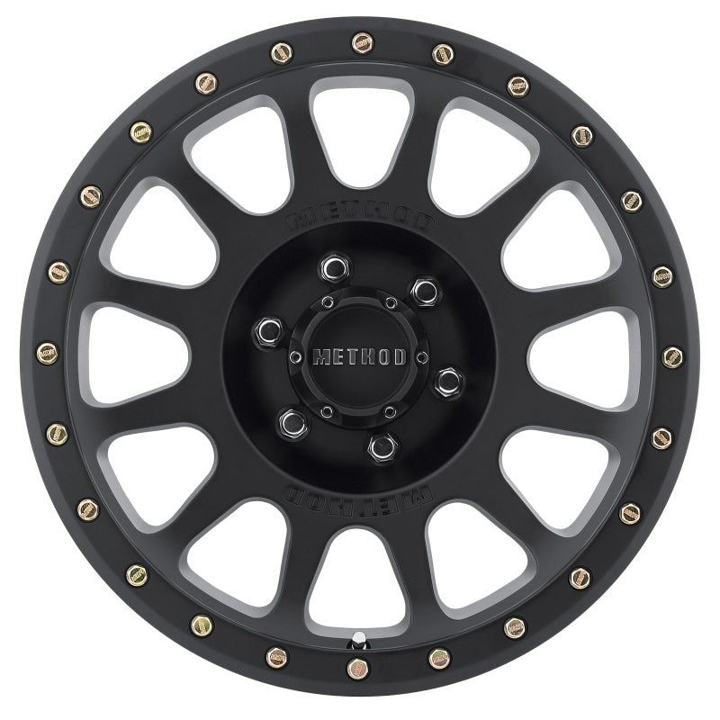 Top view of Method Wheels MR305 NV Matte Black Wheel showcasing the iconic 12 window design and debossed Method logo, ideal for off-road enthusiasts.