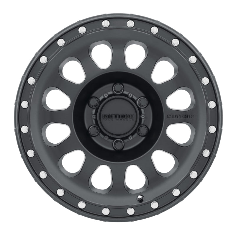 Top view of the Method MR315 17x8.5 Matte Black Wheel, highlighting its bold 12 spoke design and debossed Method logo for a stylish off-road look.