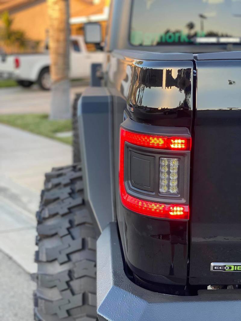 Close-up image of Jeep Gladiator JT equipped with ORACLE Lighting's Flush Mount LED Tail Lights during nighttime.