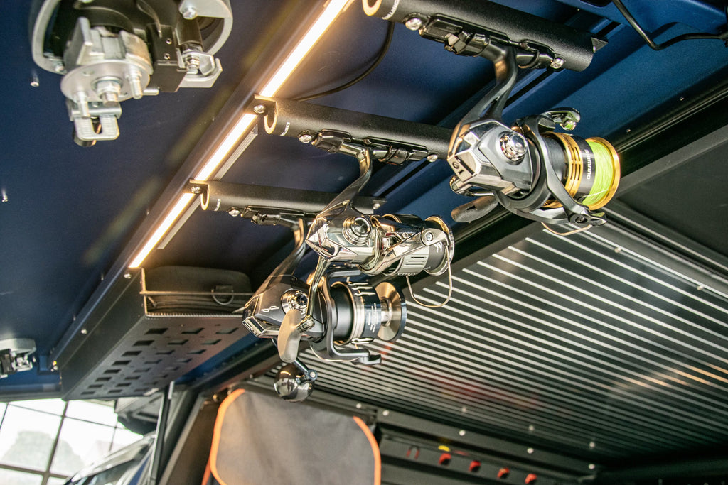 Interior angle of Dirtbox Overland Fishing Reel Mount featuring fishing reels mounted overhead, emphasizing easy access for anglers.