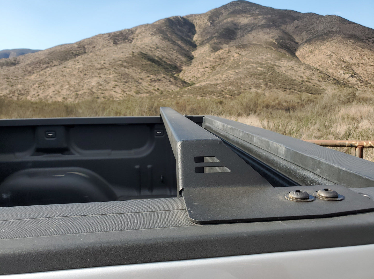Close-up of a Range Industries bed rack installed on a 2014-2018 Silverado/Sierra 1500, highlighting the sturdy construction and clean aesthetic.