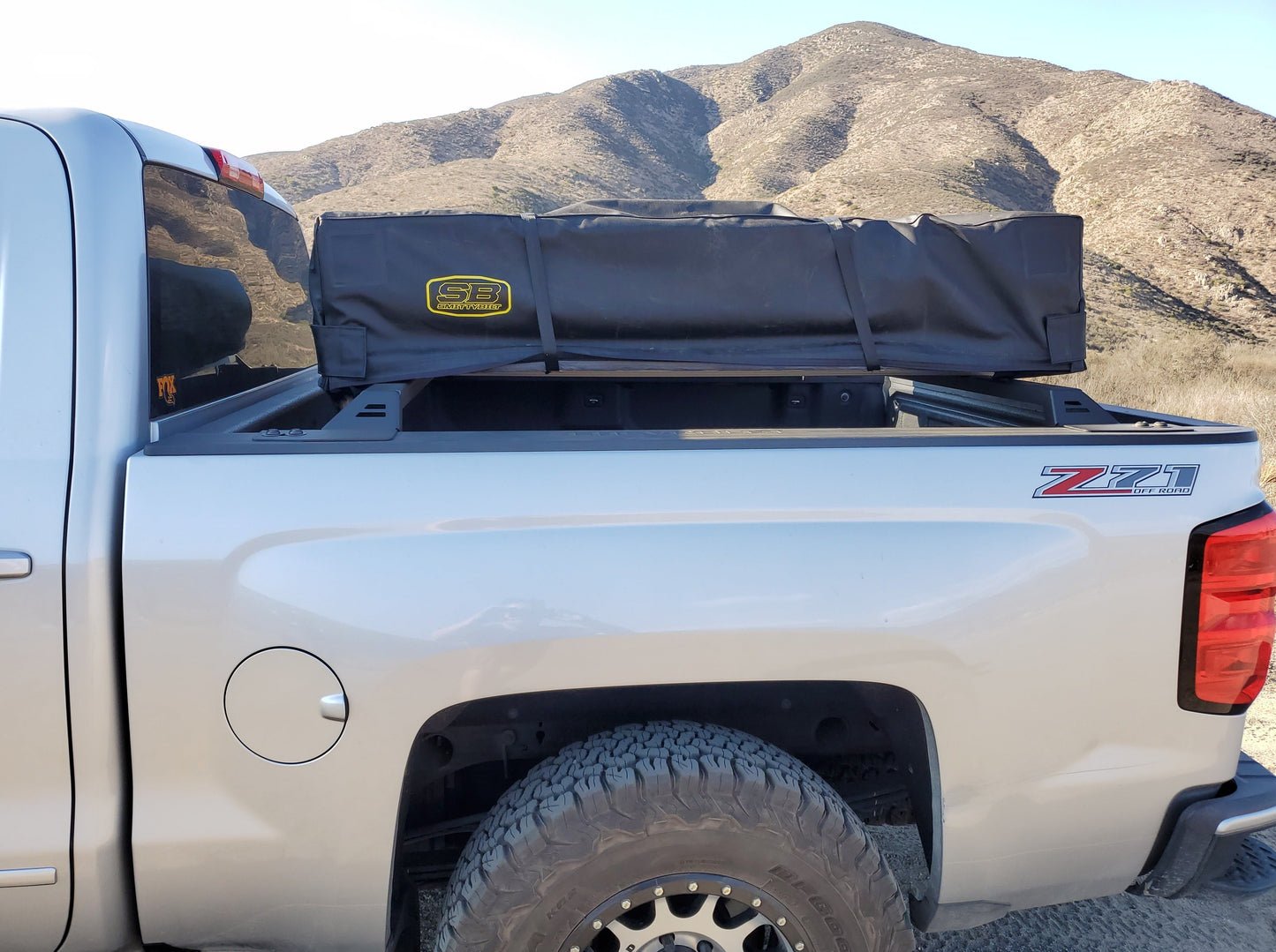 2014-2018 Silverado/Sierra 1500 Bed Rack by Range Industries, showcasing a rooftop tent securely mounted on the truck bed.