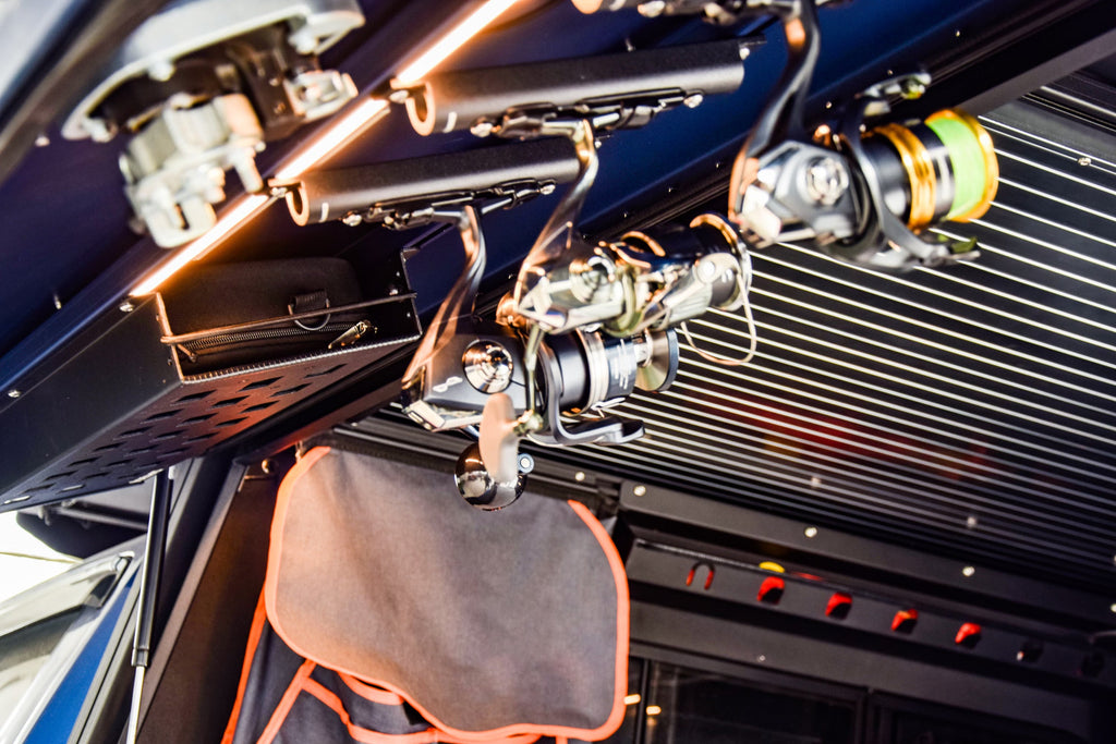 Close-up look at the functional design of the Dirtbox Overland Fishing Reel Mount with fishing reels mounted, ideal for overland camping enthusiasts.