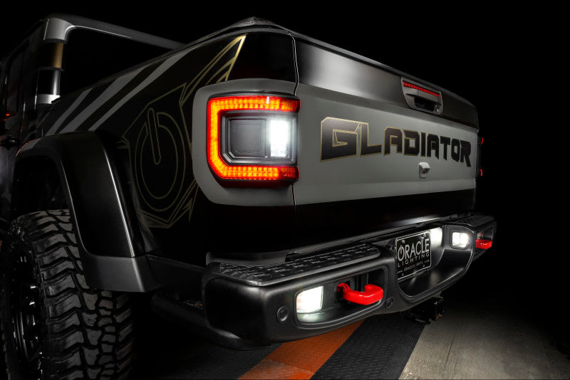 Jeep Gladiator JT with ORACLE Lighting Flush Mount LED Tail Lights, illuminated against a dark background.