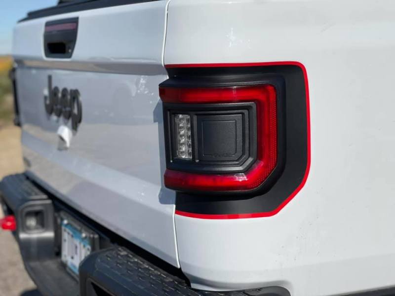 Jeep Gladiator JT equipped with ORACLE Lighting Flush Mount LED Tail Lights against a scenic background.