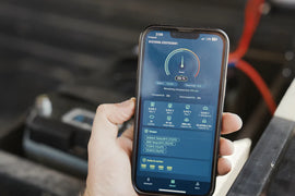 Bluetooth monitoring app for 100Ah LiFePO4 Battery by Lone Peak Camper and Accessories, displaying battery status and charge information on a smartphone.