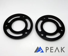 PEAK Suspension Silverado ZR2 Leveling Kit components showcasing precision CNC machined billet aluminum spacers in black, designed for enhanced durability and performance.