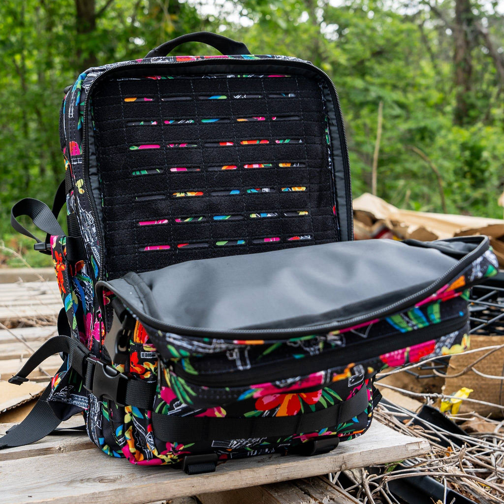A person hiking with the Combat Iron Apparel 25L Sack™ Original All-Day Molle Backpack with Pouch in a beautiful green setting.