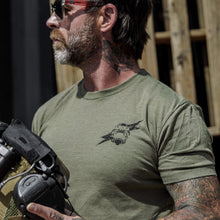 Load image into Gallery viewer, Tattooed man flexing in an olive green t-shirt that says 'Scars Remind You That You're Alive' by Combat Iron Apparel.