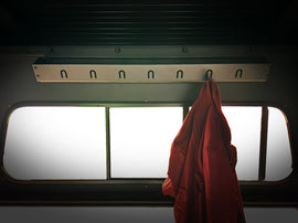 Inner Storage accessory from Dirtbox Overland featuring a clothing hanger with a red jacket hanging, designed for organized vehicle interiors.