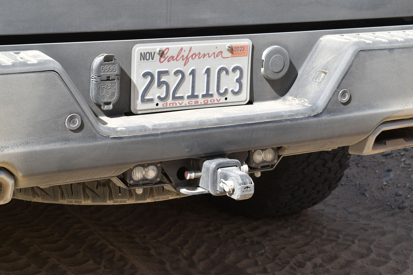Rear view of a 2019+ Silverado 1500 featuring the Range Industries rear facing light mount with Baja Designs S2 lights activated, showcasing secure installation.