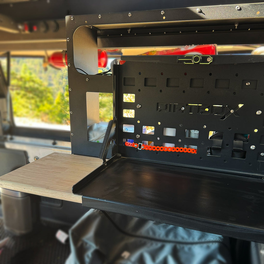 Dirtbox Overland Folding Camp Table with Cutting Board & Side Molle Box - Functional table and storage space in a truck bed.