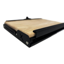 Load image into Gallery viewer, Side view of the Dirtbox Overland Folding Camp Table with Cutting Board, highlighting the sleek design and wooden cutting board.