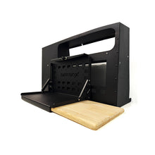 Load image into Gallery viewer, DirtBox Overland Folding Camp Table with Cutting Board &amp; Side MOLLE Box in action, showcasing the integrated cutting board and MOLLE storage.