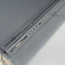 Load image into Gallery viewer, Detailed view of the aluminum surface and fastening system of the Transformer Drop Center Flatbed by Dirtbox Overland, highlighting its durability and construction.