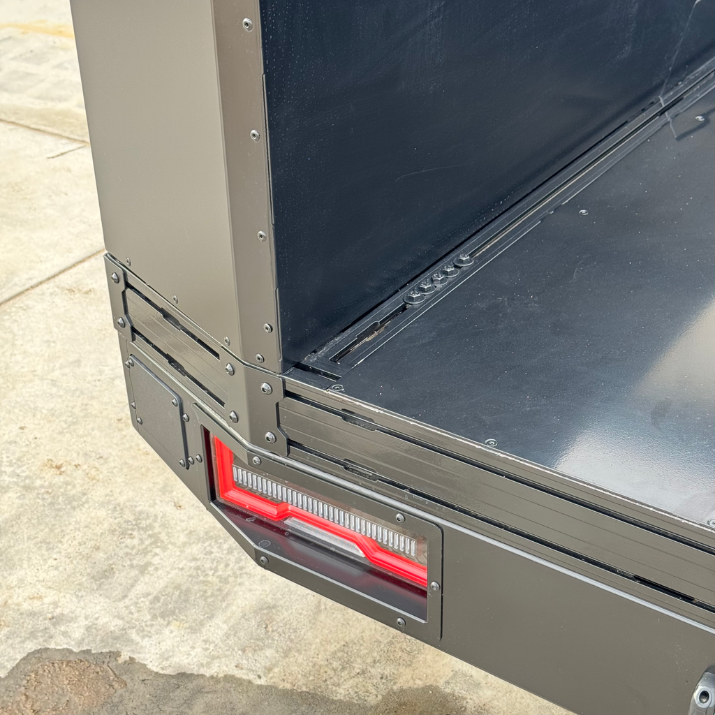 Side angle of the Transformer Drop Center Flatbed by Dirtbox Overland, featuring functional elements and the sleek profile ideal for overlanding.