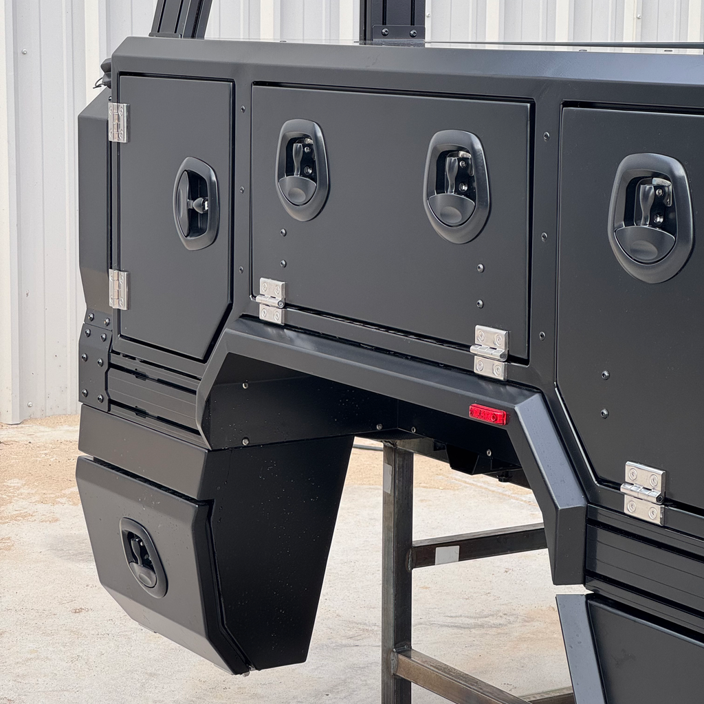 Overview of the Transformer Drop Center Flatbed by Dirtbox Overland, showing its modular storage options and heavy-duty construction for outdoor use.