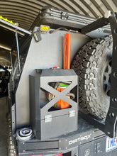 Load image into Gallery viewer, Jerry Can Holder by Dirtbox Overland fitted on a vehicle, demonstrating versatility and sturdy construction for outdoor activities.