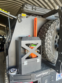 Jerry Can Holder by Dirtbox Overland fitted on a vehicle, demonstrating versatility and sturdy construction for outdoor activities.