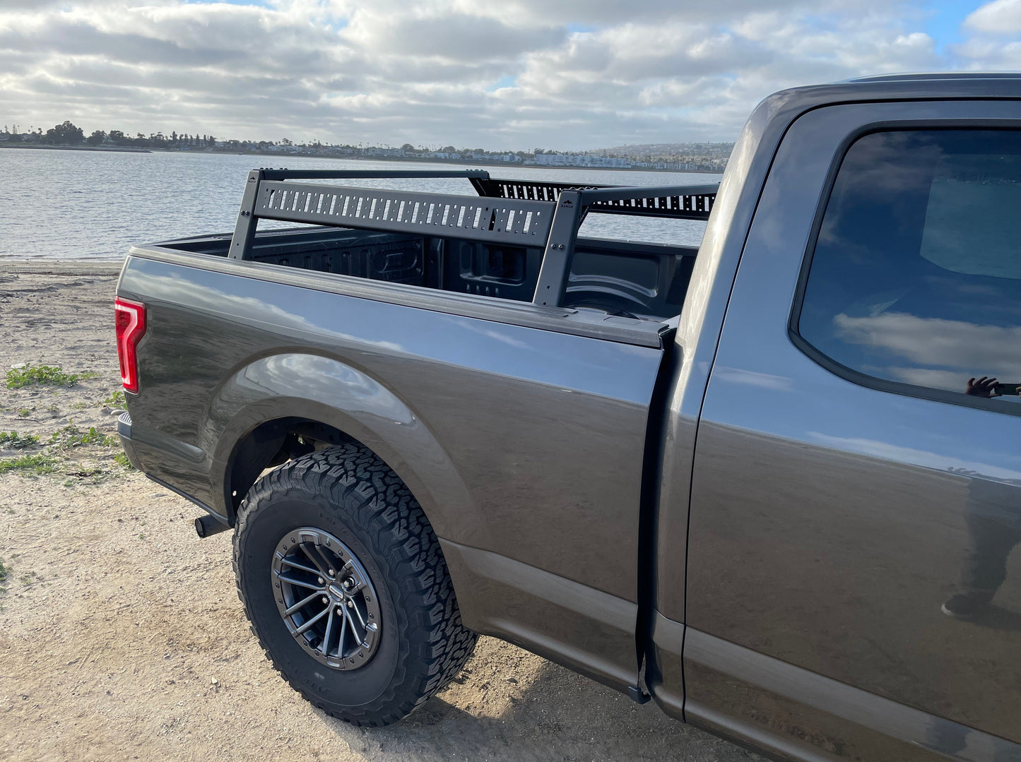 Detailed view of the Range Industries 2015+ F-150 Mid Height Rooftop Tent Rack Kit on a Ford F-150, showcasing the truck's custom features and outdoor readiness.