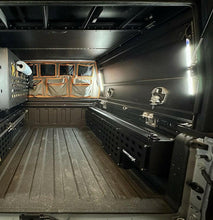 Load image into Gallery viewer, Interior view of a truck bed showcasing the Flush-Mount In-Bed Tool Box by Dirtbox Overland, highlighting its organized layout and ample storage space.