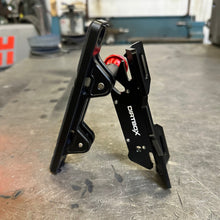 Load image into Gallery viewer, Dirtbox Overland Quick Release Fire Extinguisher Mount angled to highlight the sturdy black aluminum construction and vibrant red release button.