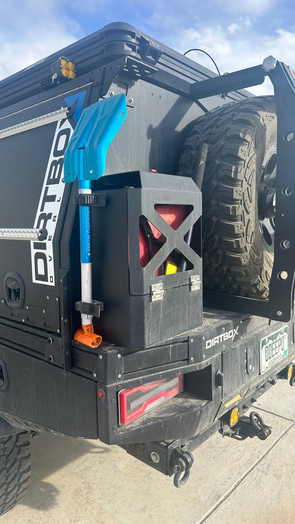 Durable Jerry Can Holder from Dirtbox Overland securely mounted on the back of a vehicle, showcasing its robust design and functionality for off-road adventures.