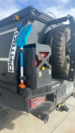 Durable Jerry Can Holder from Dirtbox Overland securely mounted on the back of a vehicle, showcasing its robust design and functionality for off-road adventures.