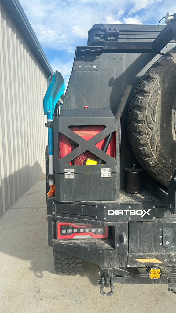 Side view of the Dirtbox Overland Jerry Can Holder attached to a vehicle, showcasing the impressive mounting options for adventure enthusiasts.