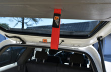 Load image into Gallery viewer, Installed A6™ Rear Lift Gate Hatch Pull Assist Strap in a Toyota 4Runner, showcasing its vibrant red color and functionality, provided by Agency6.com.