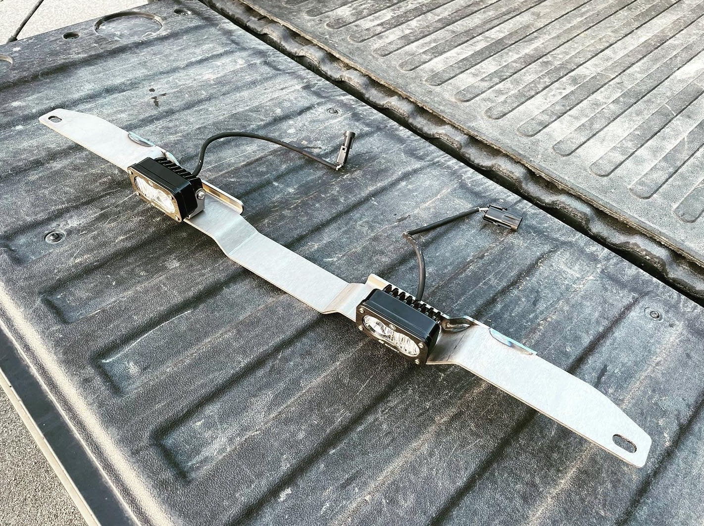 A 2019+ Silverado 1500 tailgate with the Range Industries rear facing light mount showing dual light setup and wiring, emphasizing quality craftsmanship.