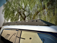 Load image into Gallery viewer, Close-up of the side profile of the 'Laguna' roof rack for Rivian R1T by Range Industries, highlighting its durable mounting brackets and stylish finish.