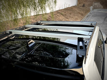 Load image into Gallery viewer, Bird's-eye view of the 'Laguna' Rivian R1T Compatible Roof Rack from Range Industries, showcasing its sturdy construction and perfect fit on the Rivian R1T, designed for versatile storage.