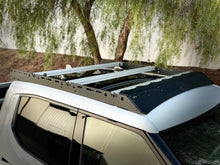 Load image into Gallery viewer, Close-up view of the 'Laguna' Rivian R1T Compatible Roof Rack by Range Industries, featuring aluminum side panels and sleek design, ideal for carrying outdoor gear.