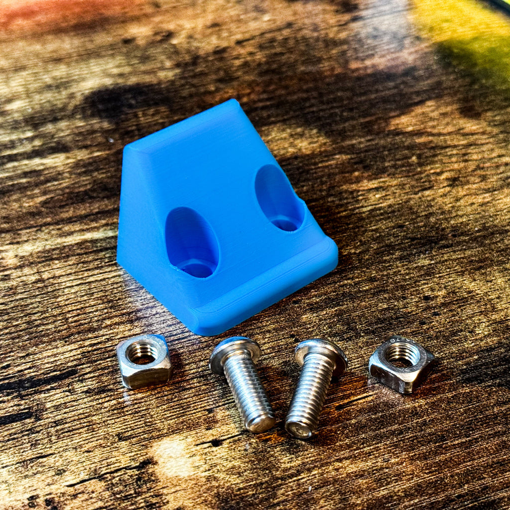 Blue Canopy Camper Rear Camera Relocation Mount by Dirtbox Overland featuring screws and nuts arranged on wood.