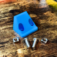 Load image into Gallery viewer, Blue Canopy Camper Rear Camera Relocation Mount by Dirtbox Overland featuring screws and nuts arranged on wood.