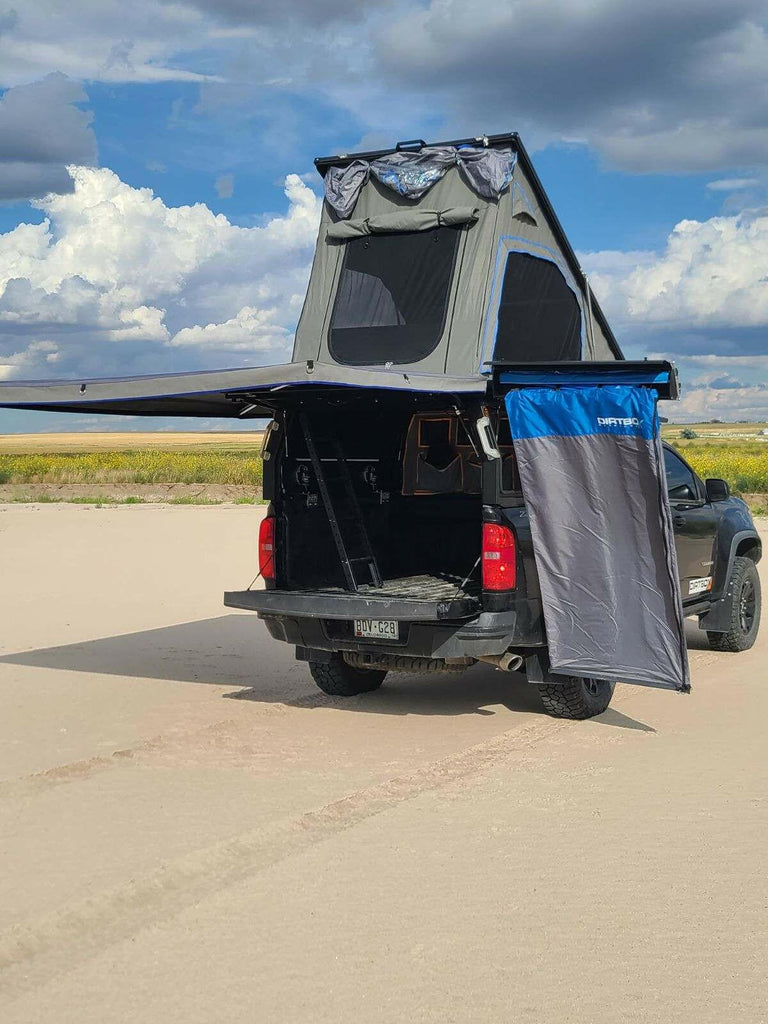 Dirtbox Overland 90 Degree Swing Out Bracket showcased on a truck with a tent setup and awning deployed in an outdoor setting.