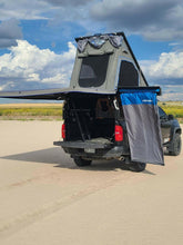 Load image into Gallery viewer, Dirtbox Overland 90 Degree Swing Out Bracket showcased on a truck with a tent setup and awning deployed in an outdoor setting.
