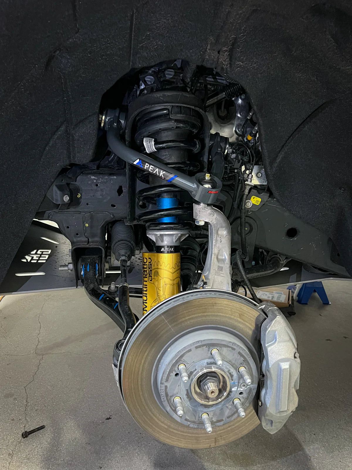 PEAK Tubular Upper Control Arms installed on a 2019+ Silverado/Sierra 1500 showcasing enhanced suspension performance, featuring robust materials and design improvements for better handling and alignment.