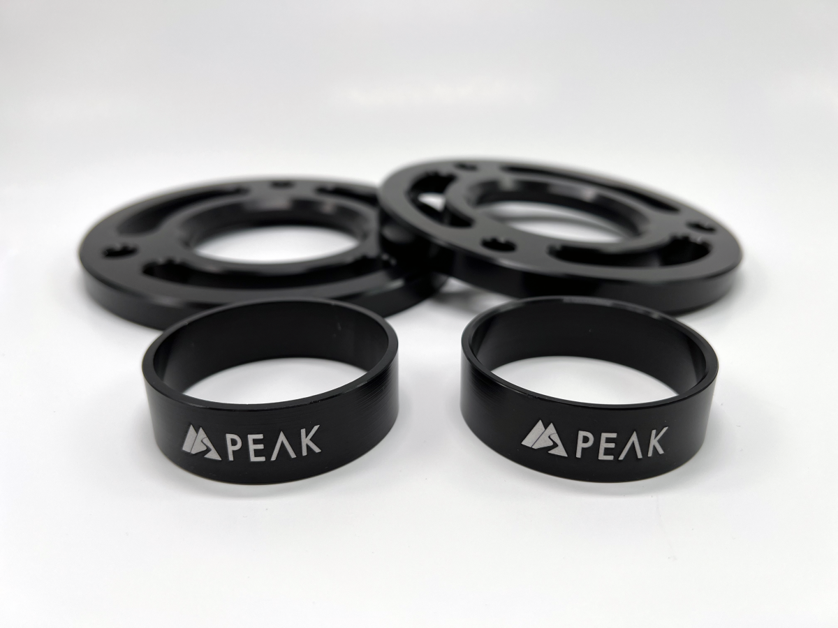 Lift blocks and spacers from the PEAK SUSPENSION Summit Kit designed for Silverado ZR2/Sierra AT4X, showcasing quality and durability.