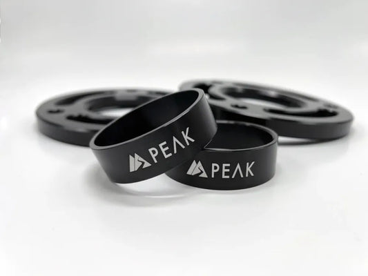PEAK SUSPENSION 2 Piece Collar Lift Kit for Silverado ZR2 and Sierra AT4X, featuring CNC machined billet aluminum build and sleek black finish.