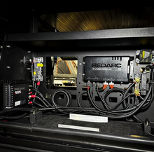 Load image into Gallery viewer, Interior view of the Dirtbox Overland Side Molle Box, highlighting electronics and organized wiring connections.