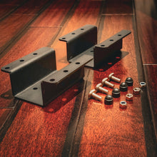 Load image into Gallery viewer, Side Hanging Water Tank Mounting Bracket from Dirtbox Overland, featuring two black metal brackets and assorted bolts and nuts on a wooden surface.