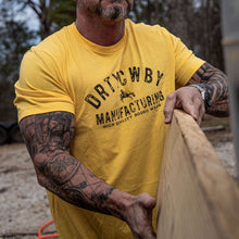 Load image into Gallery viewer, Muscular man wearing a bright yellow t-shirt that displays 'DRTYCWBY MANUFACTURING - HIGH QUALITY RODEO WEAR', representing the Original Dirty Cowboy MFG by Combat Iron Apparel.