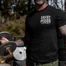 Load image into Gallery viewer, Close-up of the front of a black t-shirt featuring 'Shoot Your Local Pedos' in white text, from Combat Iron Apparel.