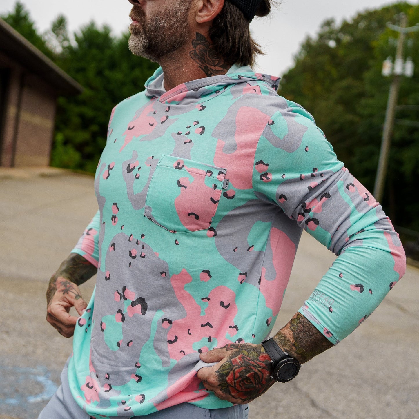 Detail view of the camouflage patterned Men's Outdoors Long Sleeve Performance Hoodie by Combat Iron Apparel, emphasize texture.