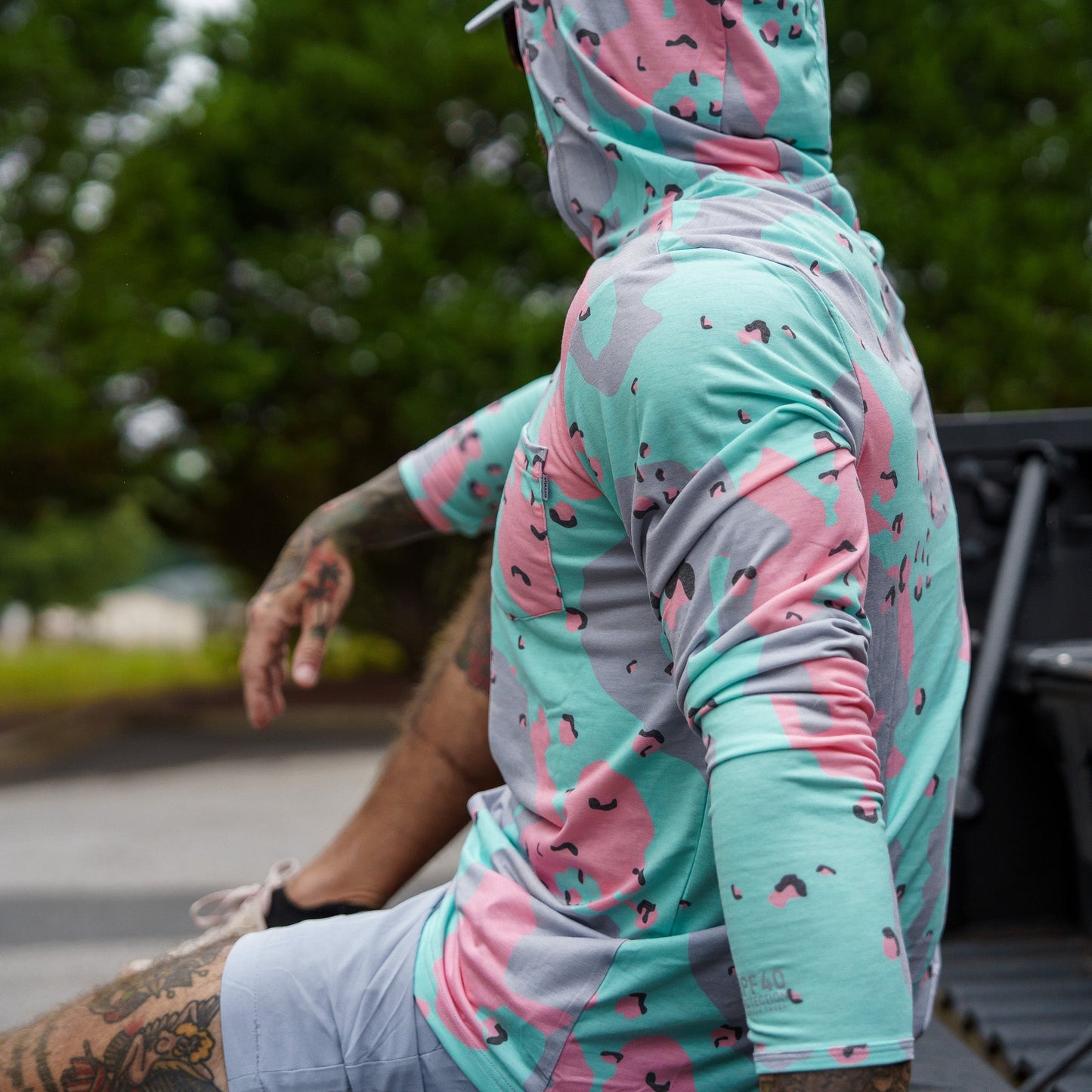 Men's Outdoors Long Sleeve Performance Hoodie by Combat Iron Apparel showcased in a vibrant camo style.