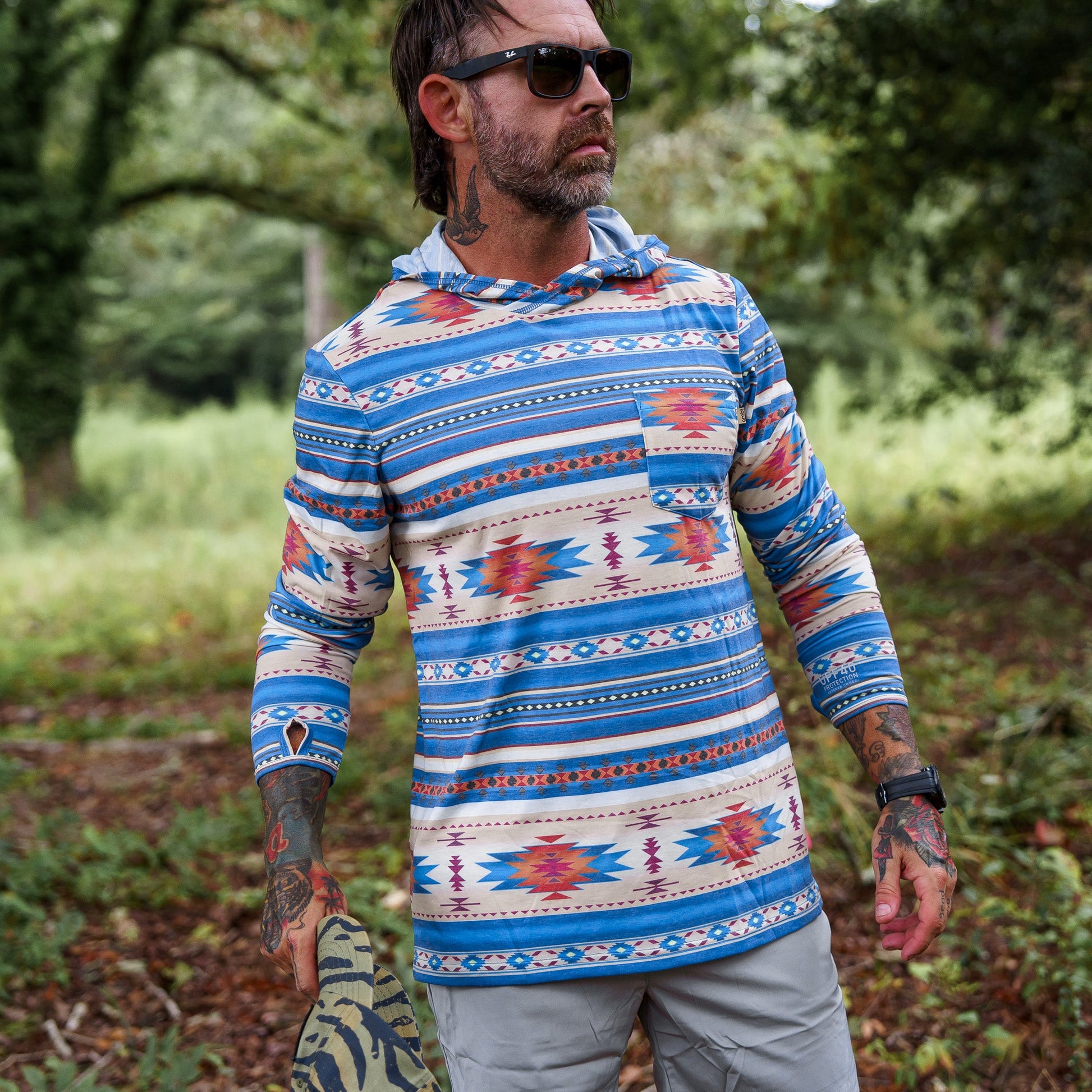 Men's Outdoors Long Sleeve Performance Hoodie by Combat Iron Apparel modeled outdoors, showcasing the breathable design.